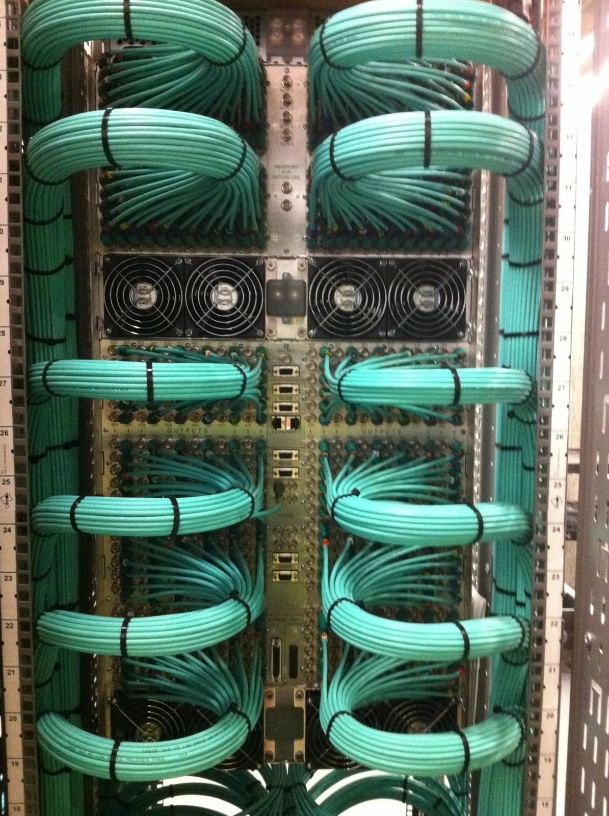 Rack cable management Teal broadcast cabling neatly dressed into a technical rack built and tested by Mottram Broadcast
