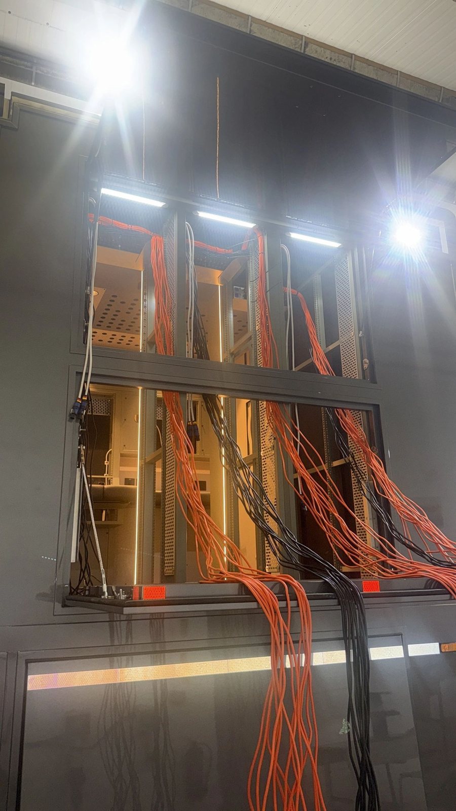 Cable install, live facility Orange broadcast cabling installed into overhead containment during a Mottram Broadcast technical fit-out